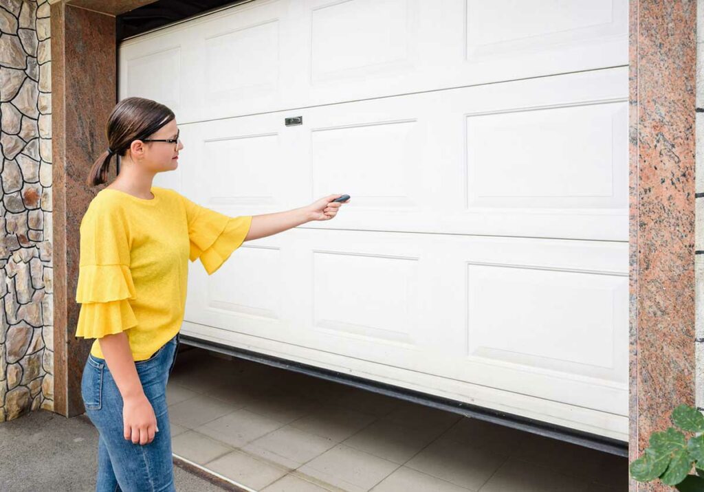 women pressing garage opener button